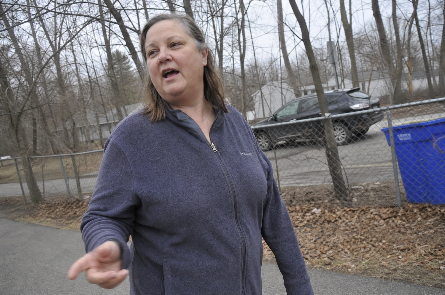 A woman in her fifties walking on a neighbourhood path